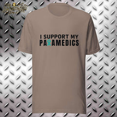 Tan t-shirt with design in the center of the chest reading, "I support my paramedics".  The "R" in paramedics is replaced with the teal PTSD awareness ribbon.
