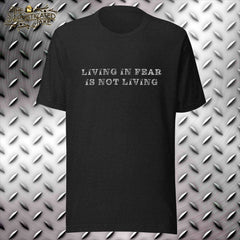 Black t-shirt with text in the center of the chest.  Text is distressed and reads, "living in fear is not living".